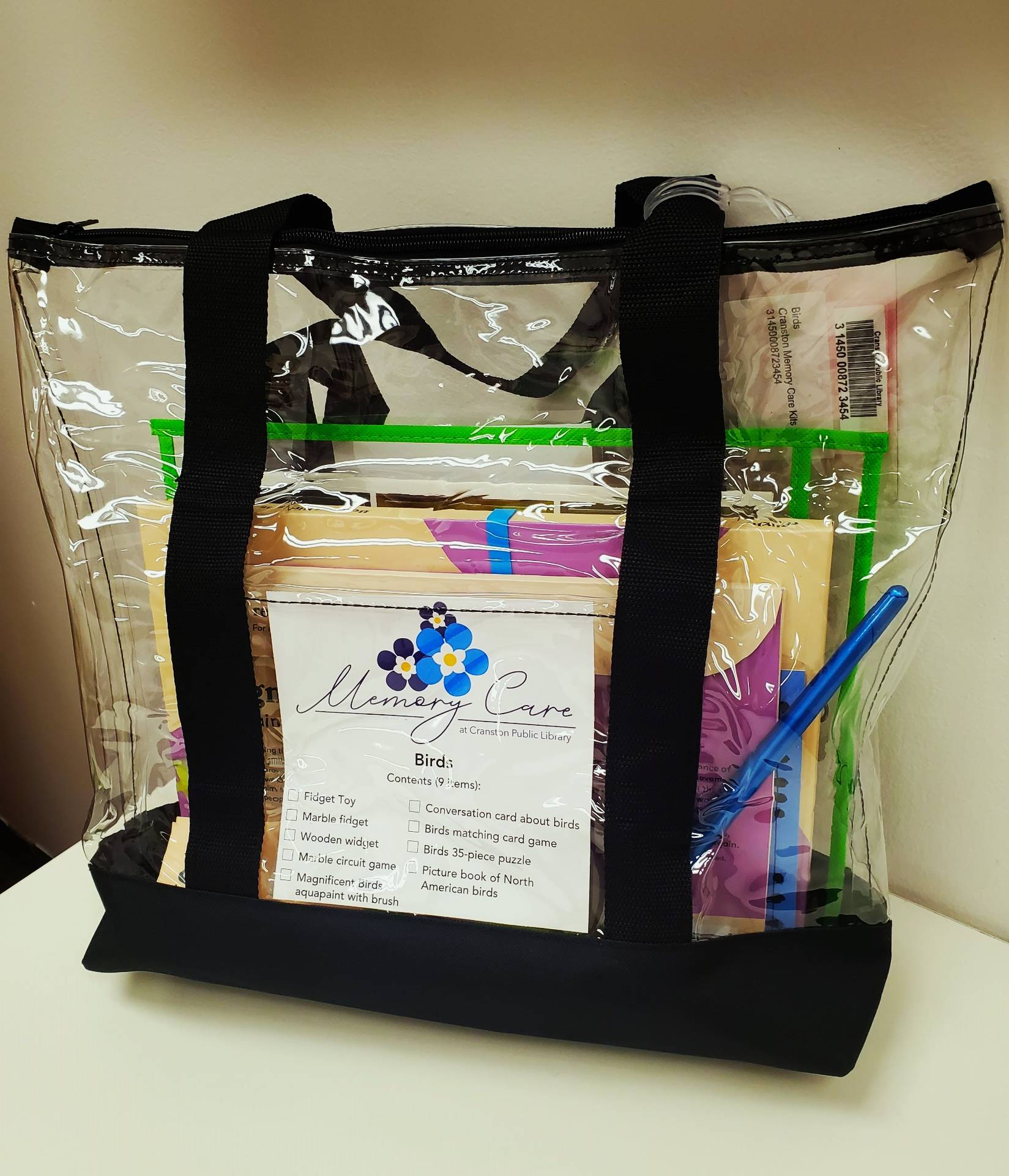 Photograph of a clear tote bag filled with memory care items and activities.